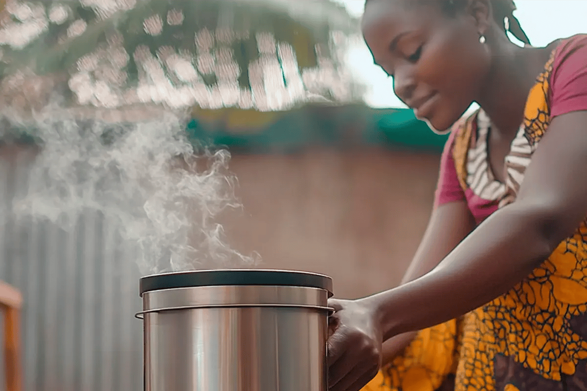 Enhanced Firewood Model Promises Greater Accuracy for Carbon Markets_An African woman making a meal on a clean cookstove_visual 1