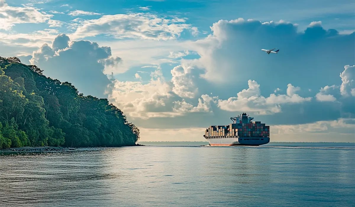 Gabon to Implement $17 Carbon Levy for Transport Emissions_A cargo ship cruising along Gabons coastline, with a commercial airplane flying above_featured