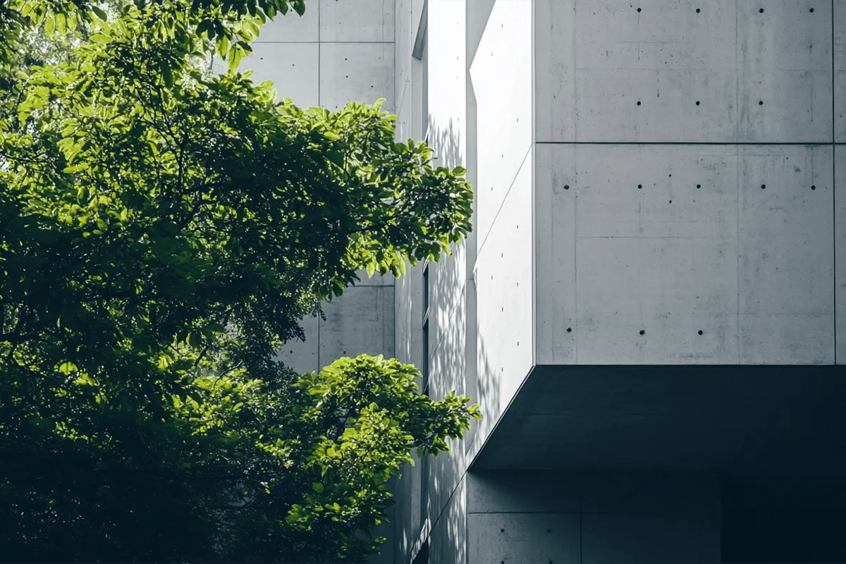 Swiss Registry Introduces Biochar Certification for Concrete Applications_A modern concrete building surrounded by green deciduous trees_visual 1